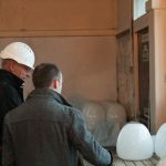 Lama Ole Nydahl being shown some original glass light fittings from the Beaufoy Institute