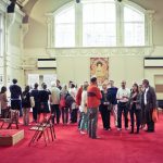 A tour group in the main hall of the Beaufoy