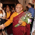 Sherab Gyaltsen Rinpoche greeted by students as he arrives at the Beaufoy