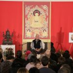 Lama Ole Nydahl on stage giving a lecture in the main hall of the Beaufoy Institute, London